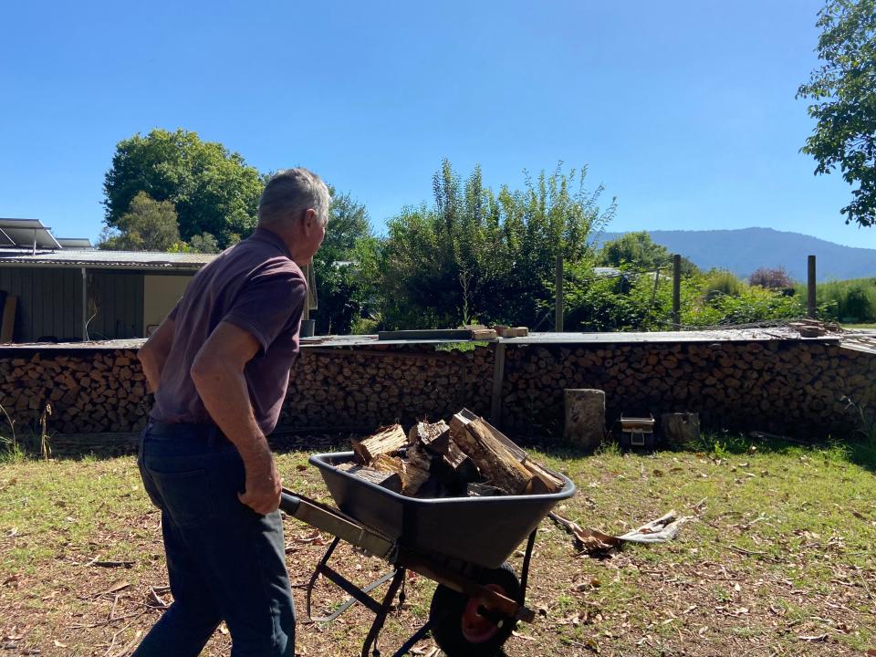 Frank Noble pushing a wheelbarrow.