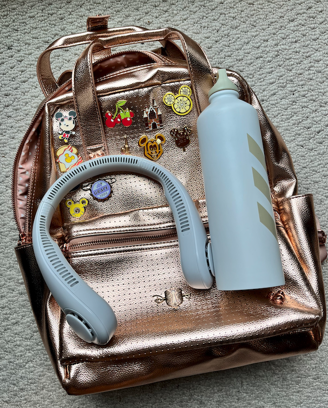 a backpack, water bottle, and portable fan