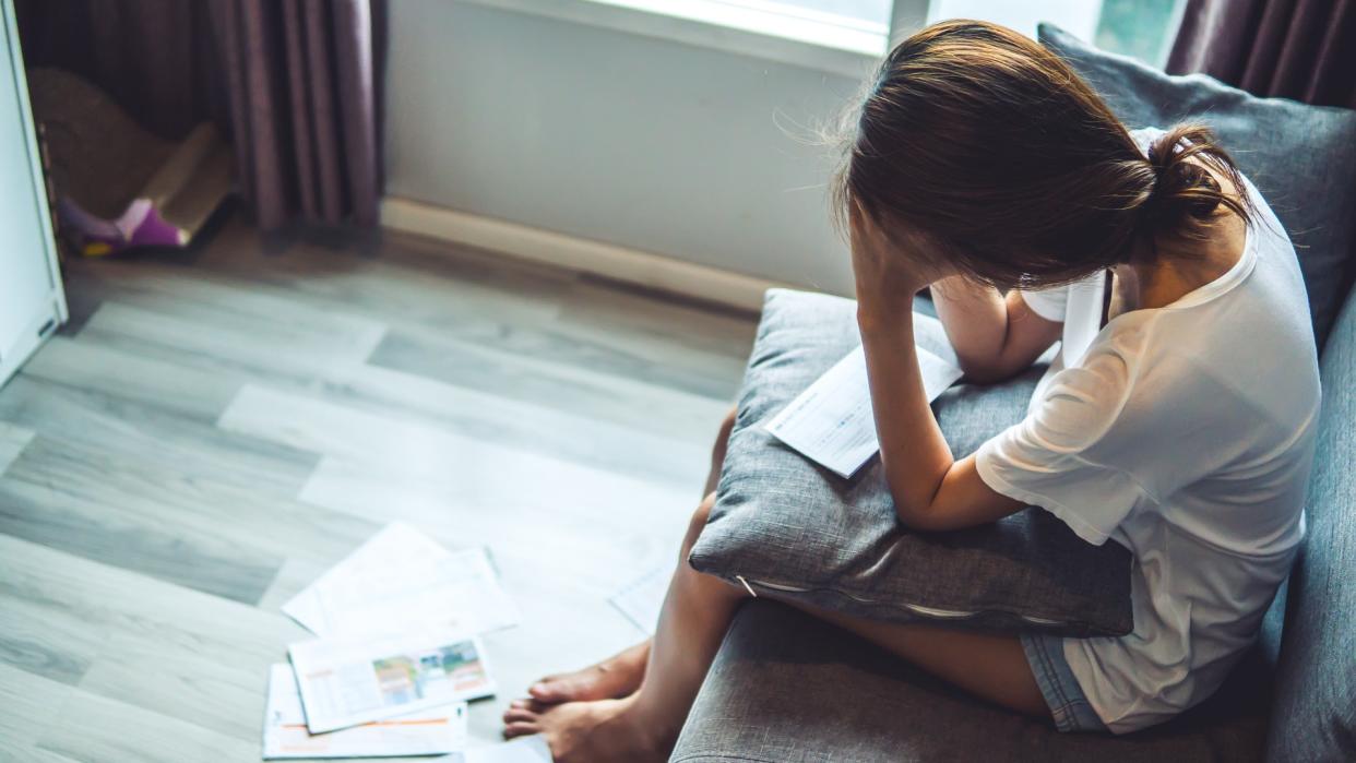 woman anxious over financial documents