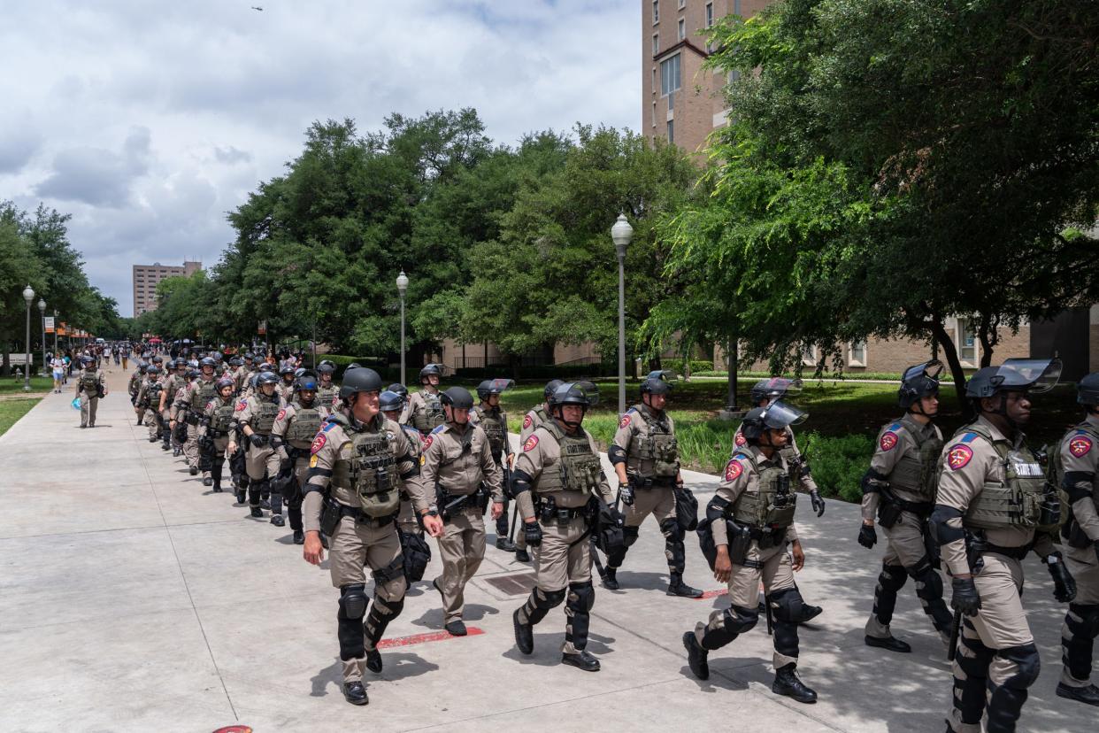 State troopers march down Speedway during a pro-Palestinian protest at the University of Texas Wednesday April 24, 2024.