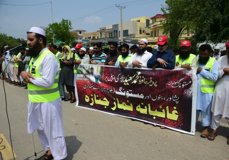 Activists of the banned Jamaat-ud-Dawa group offer absentia funeral prayers in Islamabad for victims of the Mastung bomb blast