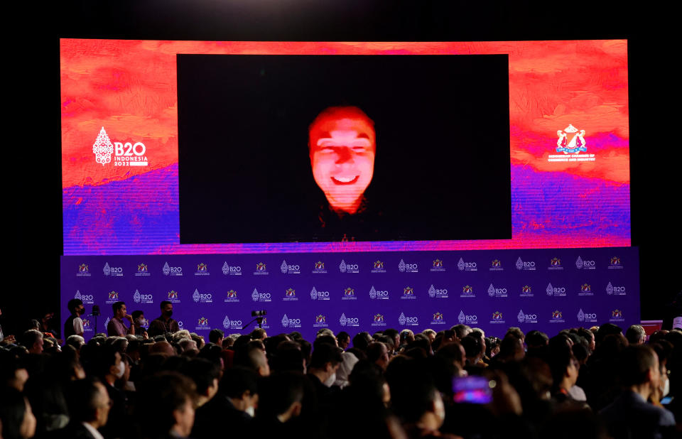 Elon Musk, Tesla Inc. CEO, is seen on the screen as he speaks virtually during the B20 Summit, ahead of the G20 leaders' summit, in Nusa Dua, Bali, Indonesia, November 14, 2022. REUTERS/Willy Kurniawan