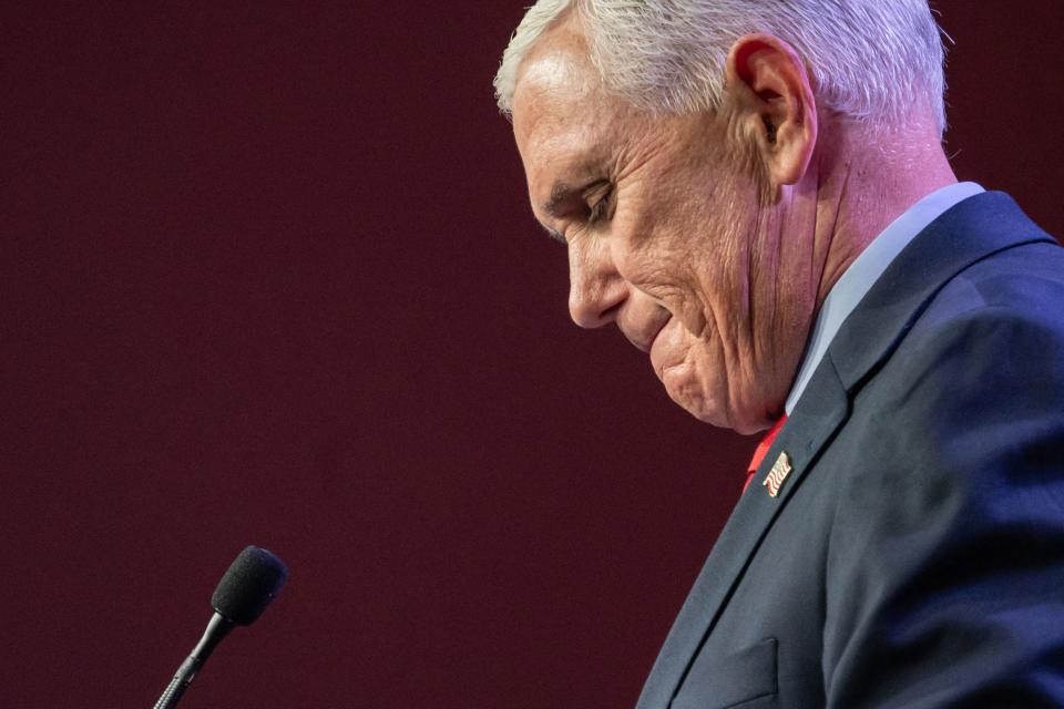 Mike Pence looks down and bites his lip.