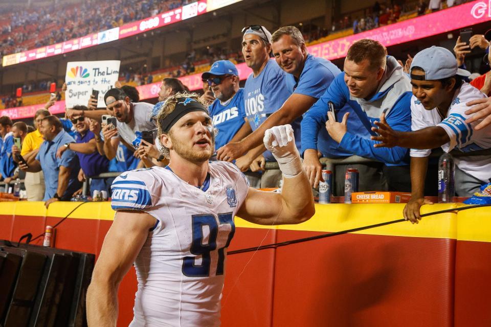 Detroit Lions defensive end Aidan Hutchinson (97) high fives fans after 21-20 win over Kansas City Chiefs at Arrowhead Stadium in Kansas City, Mo. on Thursday, Sept. 7, 2023.