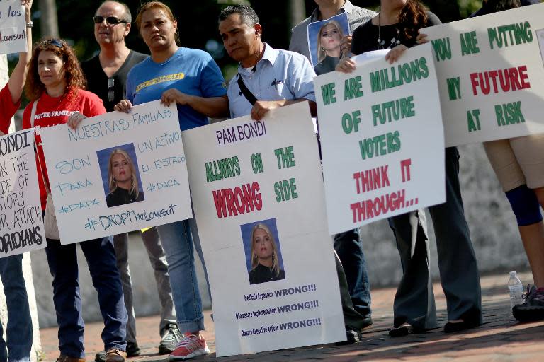 Protesters call for Florida to be withdrawn from a list of 25 states that joined a lawsuit against US President Barack Obama's Executive Action on Immigration, on January 22, 2015 in Miami