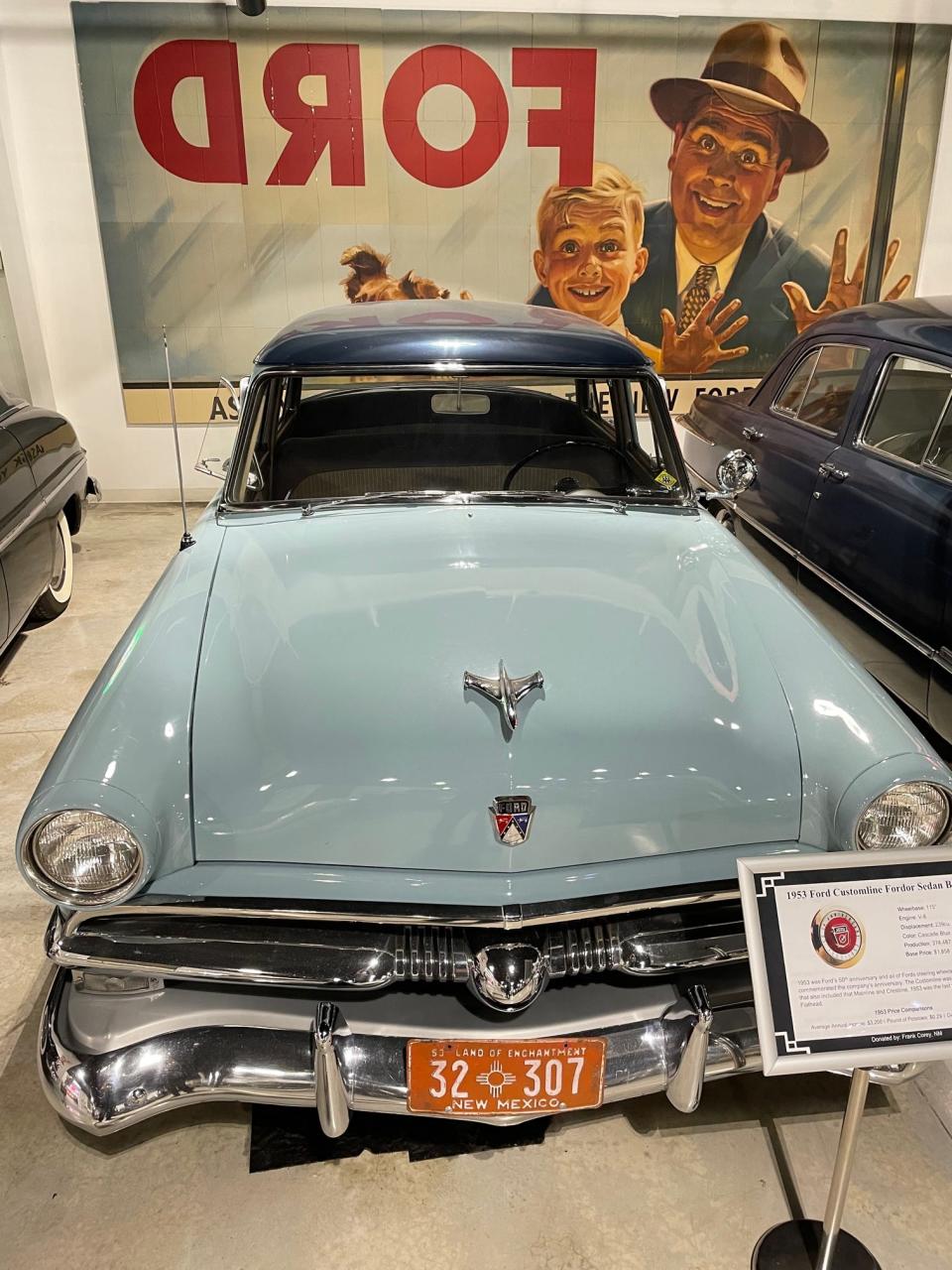 A father and son from a classic Ford campaign ogle a 1953 beauty at the Ford museum.