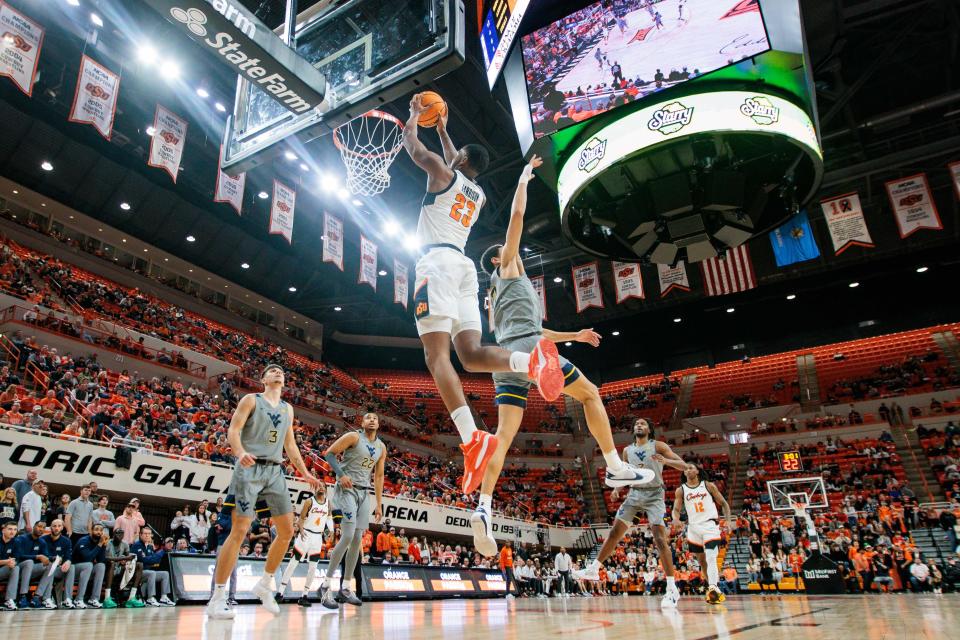 OSU center Brandon Garrison (23) puts up a shot against West Virginia during the first half of a 70-66 win Saturday at Gallagher-Iba Arena in Stillwater.