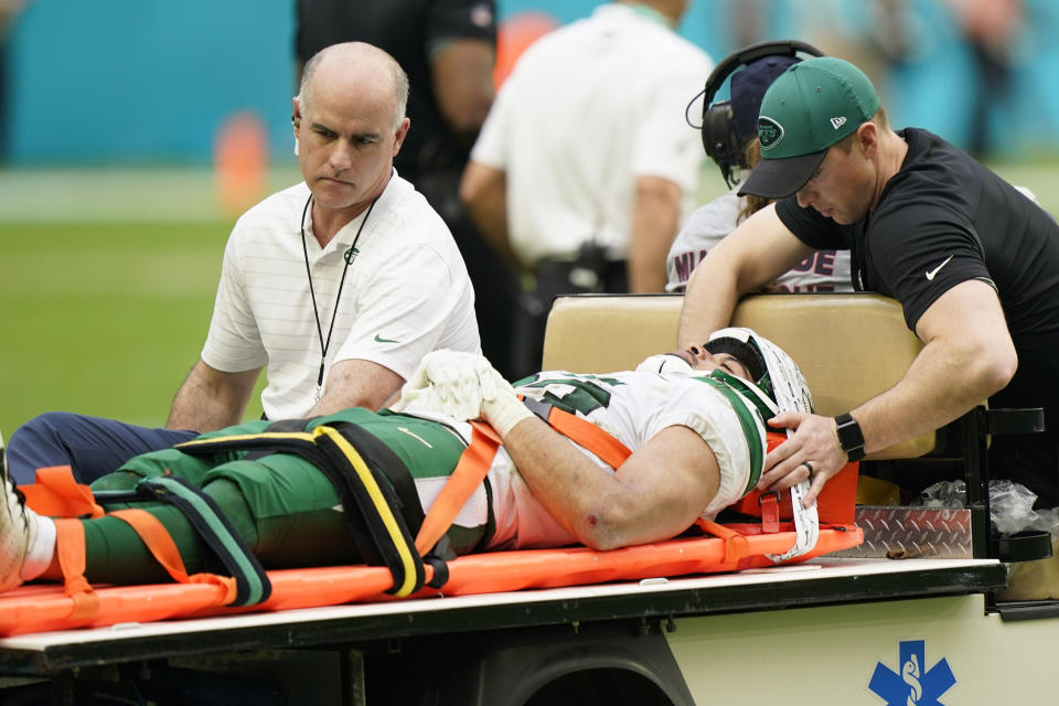 New York Jets Safety Elijah Riley (33) is removed from the game after he was injured on a play during the second half of an NFL football game against the Miami Dolphins, Sunday, Dec. 19, 2021, in Miami Gardens, Fla. (AP Photo/Lynne Sladky)