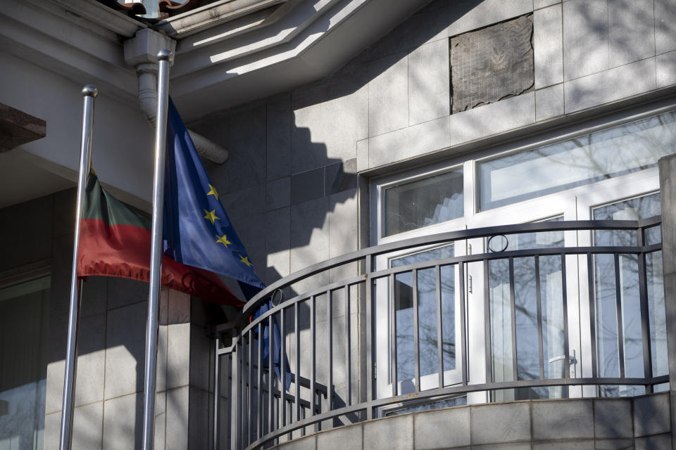 FILE - Lithuanian and European Union flags fly outside the Lithuanian Embassy in Beijing, Dec. 16, 2021. The U.S. State Department has set up an eight-person team known as the "firm" to provide help to countries cut off from Chinese trade. The team emerged after Washington stepped in to help Lithuania when the northern European country found its cargo shipments to and from China stranded two years ago during a feud over Taiwan. (AP Photo/Mark Schiefelbein)