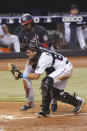 Washington Nationals' Alcides Escobar collides with Miami Marlins catcher Nick Fortes (84) during the sixth inning of a baseball game, Tuesday, Sept. 21, 2021, in Miami. Escobar scored on the play. (AP Photo/Marta Lavandier)