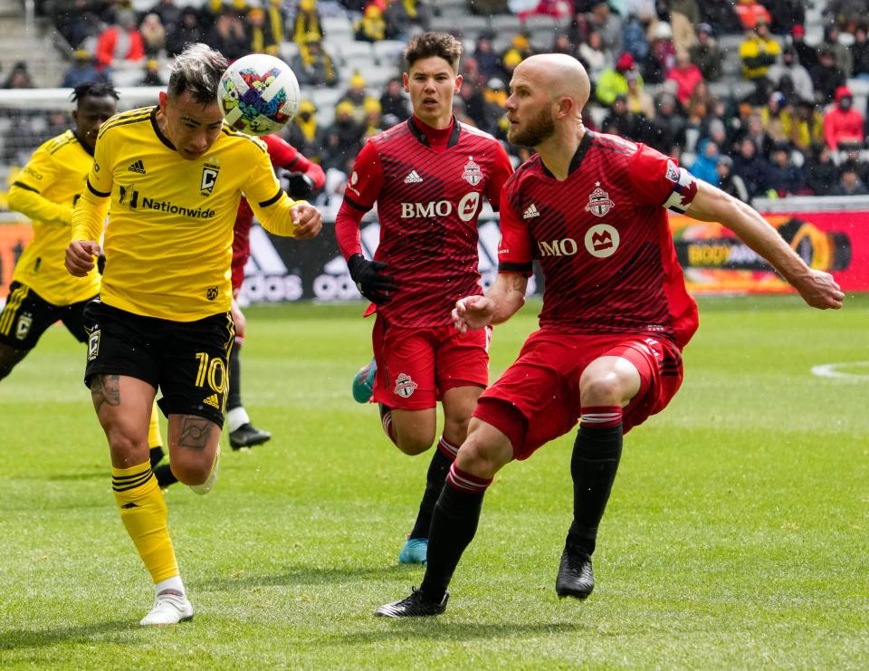 Sat., Mar. 12, 2022; Columbus, Ohio, USA; Columbus Crew midfielder Lucas Zelarayán (10) has the ball as Toronto FC midfielder Michael Bradley (4) moves in to defend during the first half of a MLS game between the Columbus Crew and Toronto FC at Lower.com Field.