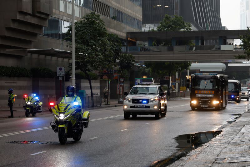 Police escort a prison van that is believed to carry media mogul Jimmy Lai in Hong Kong