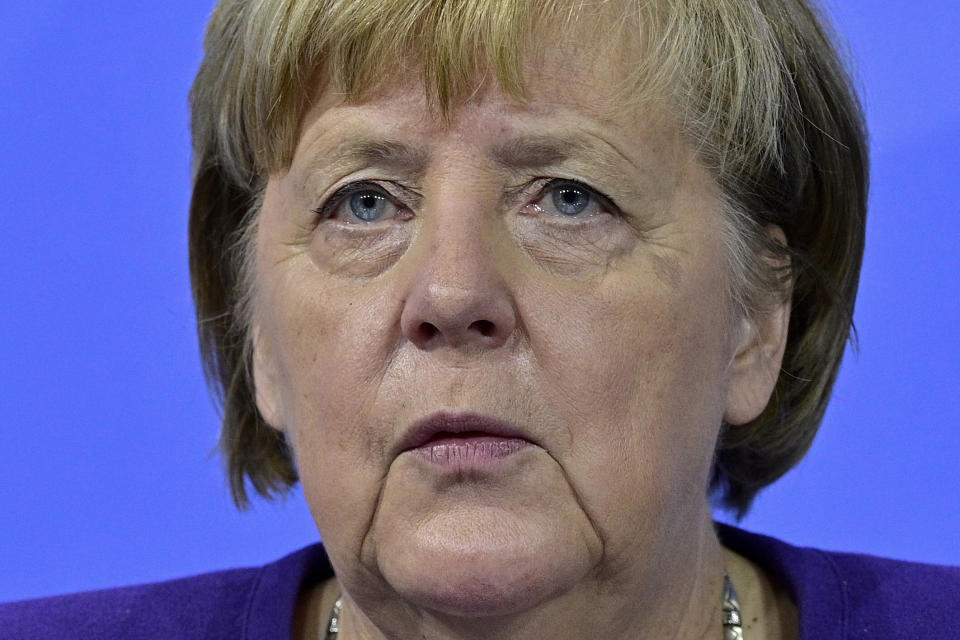 German Chancellor Angela Merkel attends a press conference following a meeting with the heads of government of Germany's federal states at the Chancellery in Berlin, Thursday, Dec. 2, 2021. Merkel said Thursday that people who aren't vaccinated will be excluded from nonessential stores, cultural and recreational venues, and parliament will consider a general vaccine mandate, as part of an effort to curb coronavirus infections that again topped 70,000 newly confirmed cases in a 24-hour period. (John Macdougall/Pool Photo via AP)