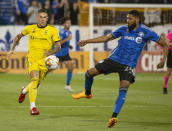 Columbus Crew's Christian Ramirez, left, and CF Montreal's George Campbell vie for the ball during the first half of an MLS soccer match Saturday, Sept. 2, 2023, in Montreal. (Peter McCabe/The Canadian Press via AP)