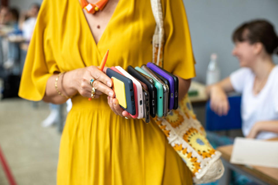 Many teachers already confiscate cell phones during classes. New guidance in the U.K. will push more schools to ban them throughout the school day. (Getty Images)