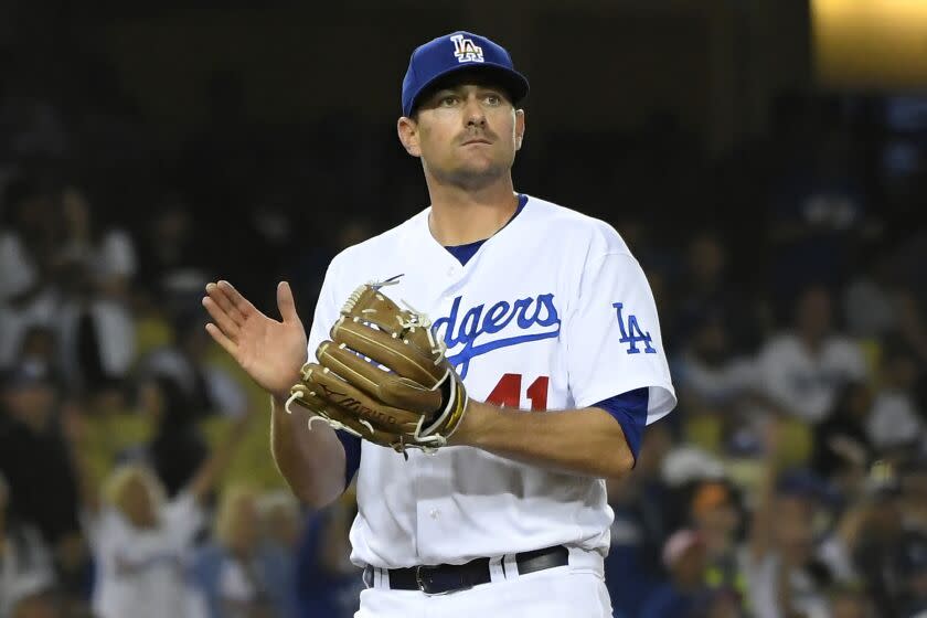 Los Angeles Dodgers relief pitcher Daniel Hudson reacts after New York Mets'  Eduardo Escobar.