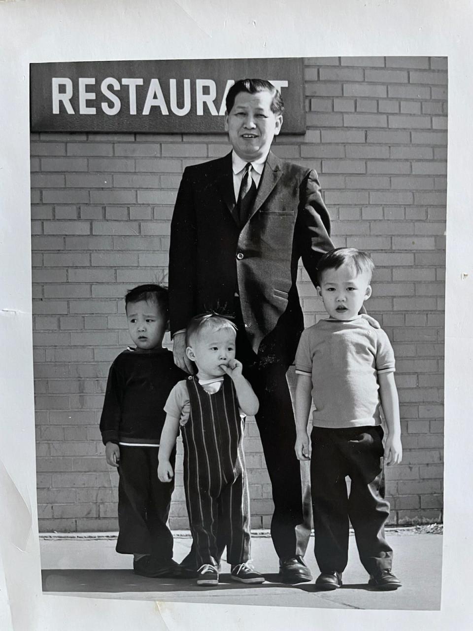 Curtis Chin, middle, is pictured with brothers Chris (left) and Craig, and their grandfather, Tom Chin.