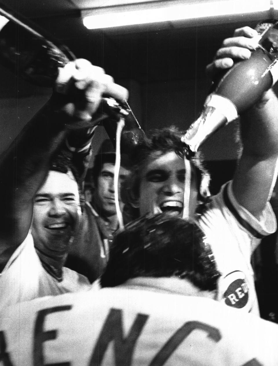 Bob Bailey and Bill Plummer douse Johnny Bench with champagne in the clubhouse after beating the Phillies in the NLCS. Between Bailey and Plummer, Pat Zachry is visible.