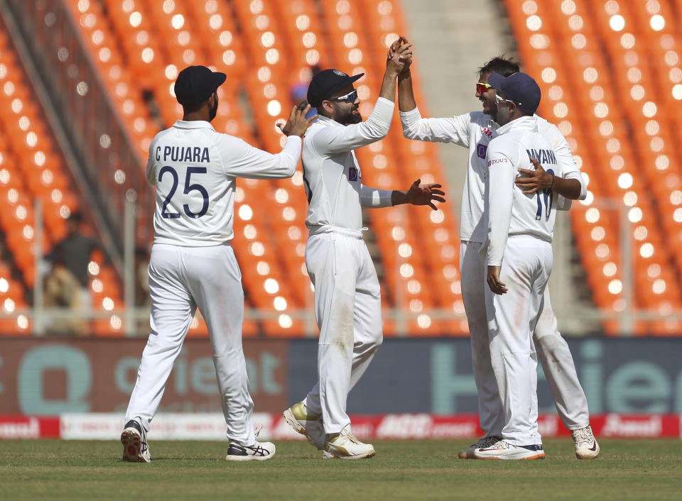 India's Axar Patel, second right, celebrates with teammates the dismissal of England's Dominic Bess during the third day of fourth cricket test match between India and England at Narendra Modi Stadium in Ahmedabad, India, Saturday, March 6, 2021. (AP Photo/Aijaz Rahi)