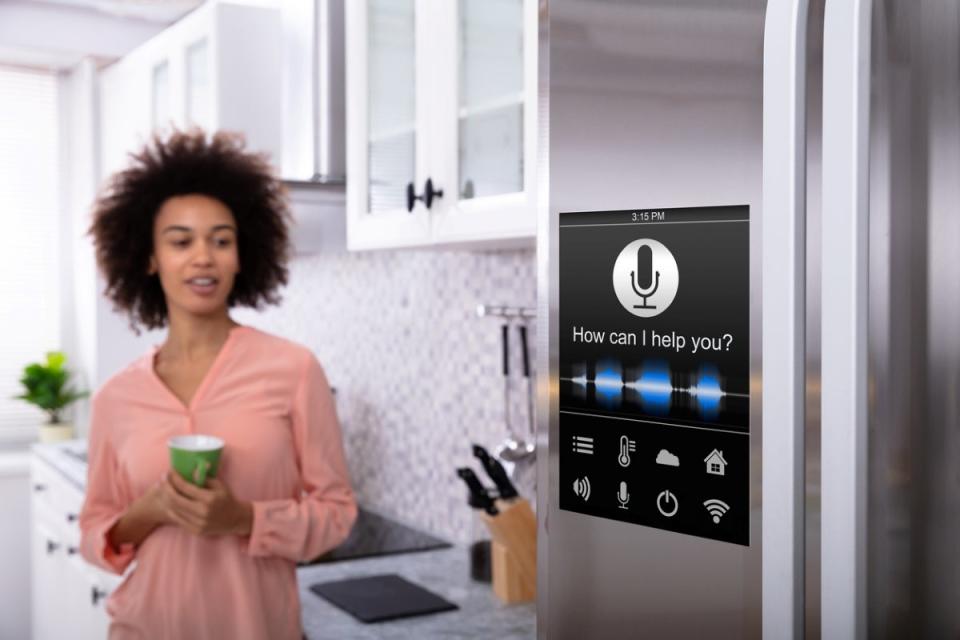 Woman using smart fridge