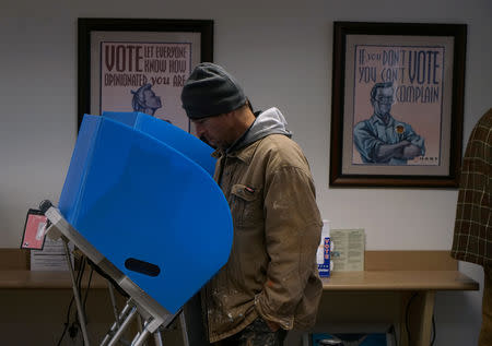 An early voter casts his vote in Athens, Georgia, U.S., October 26, 2018. REUTERS/Lawrence Bryant