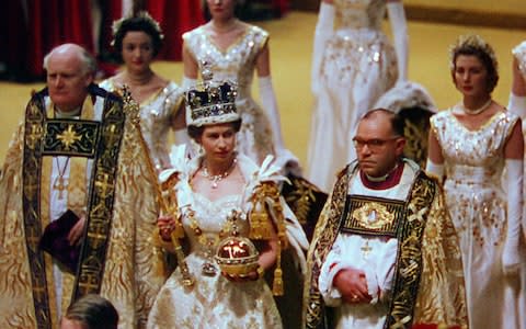 The Queen with her maids of honour and Archbishop of Canterbury during the coronation - Credit: ITV archive