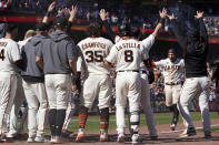 San Francisco Giants' Thairo Estrada, second from right, celebrates with teammates after hitting a two-run home run against the Pittsburgh Pirates during the ninth inning of a baseball game in San Francisco, Sunday, Aug. 14, 2022. (AP Photo/Jeff Chiu)