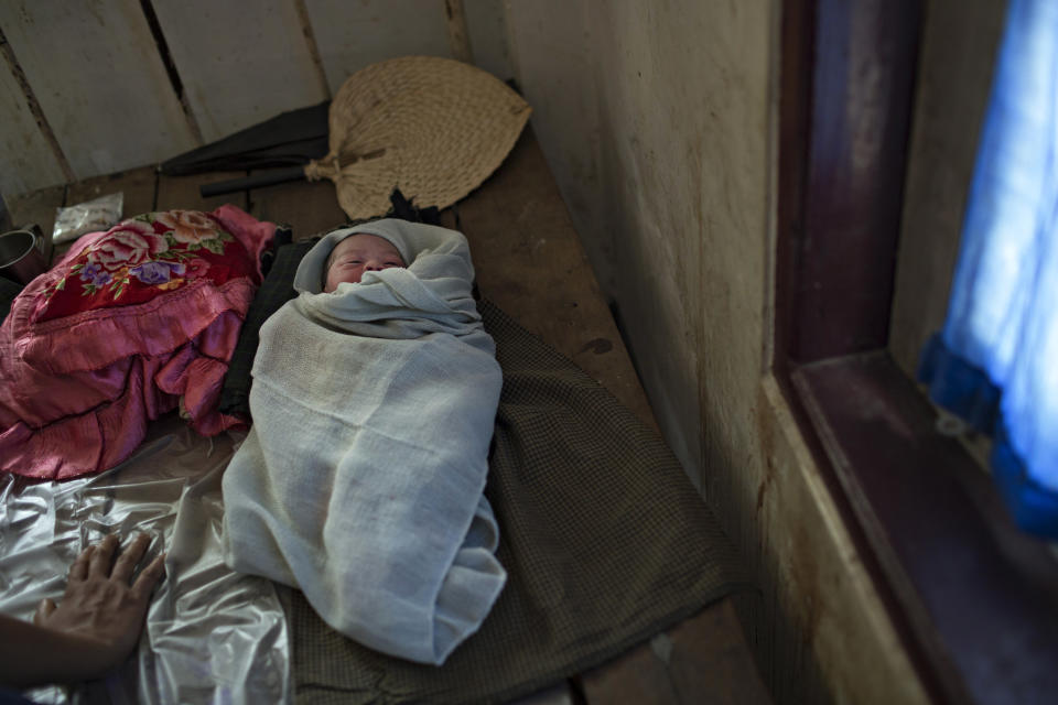 SITTWE, BURMA - MAY 07: A baby, only several hours old, sleeps in the Dar Paing Clinic in the Dar Paing refugee camp. It was born healthy but will face challenges as its family is too poor to afford enough food on May 7, 2014 in Sittwe, Burma. . 150,000 Rohingya IDP (internally displaced people) are currently imprisoned in refugee camps outside of Sittwe in Rakhine State in Western Myanmar. Medecins Sans Frontieres (MSF), the primary supplier of medical care within the camps, was banned in March by the Myanmar government. Follow up attacks by Buddhist mobs on the homes of aid workers in Sittwe put an end to NGO operations in the camps. Though some NGOs are beginning to resume work, MSF remains banned and little to no healthcare is being provided to most Rohingya IDPs. One Rohingya doctor is servicing 150,000 refugees with limited medication. Several Rakhine volunteer doctors sporadically enter the camps for two hours a day. Births are the most complicated procedures successfully carried out in the camps, requests to visit Yangon or Sittwe hospitals for life threatening situations require lengthy applications and are routinely denied. Malnutrition and diarrhea are the most widespread issues, but more serious diseases like tuberculosis are going untreated and could lead to the rise of drug resistant tuberculosis (DR-TB). (Photo by Andre Malerba/Getty Images)