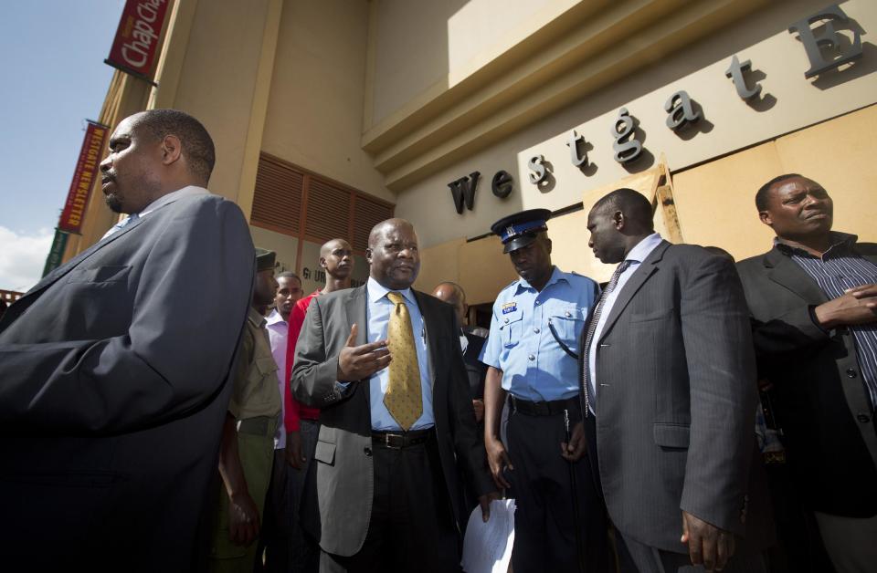 Chief Magistrate Daniel Ochenja, centre left, who is conducting the trial of four men accused of aiding the Westgate Mall gunmen, visits the mall in Nairobi, Kenya Tuesday, Jan. 21, 2014. Court officials and four handcuffed ethnic Somalis accused of aiding the gunmen who attacked Nairobi's Westgate Mall in Sept. 2013, walked through the heavily damaged shopping center on Tuesday led by Chief Magistrate Daniel Ochenja, to help the court visualize the mall's layout for the ongoing trial of the four men. (AP Photo/Ben Curtis)