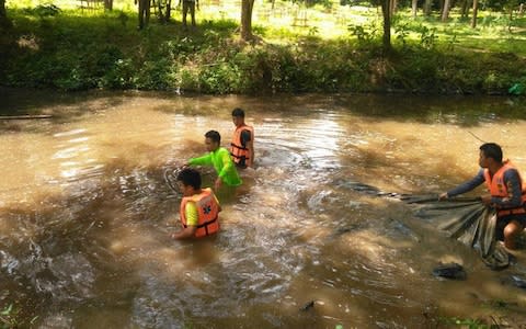 Thai police divers have been searching a local river for signs of the couple - Credit: Viral press