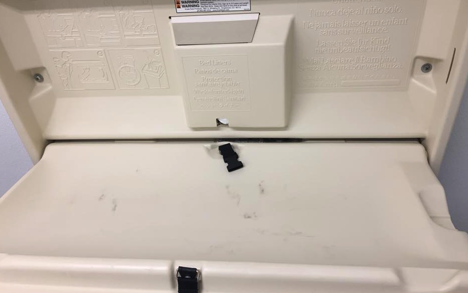 A mother claims that the black marks on a diaper-changing station in a public restroom are a result of burnt spoons. (Photo: Jessica Wayman via Facebook)