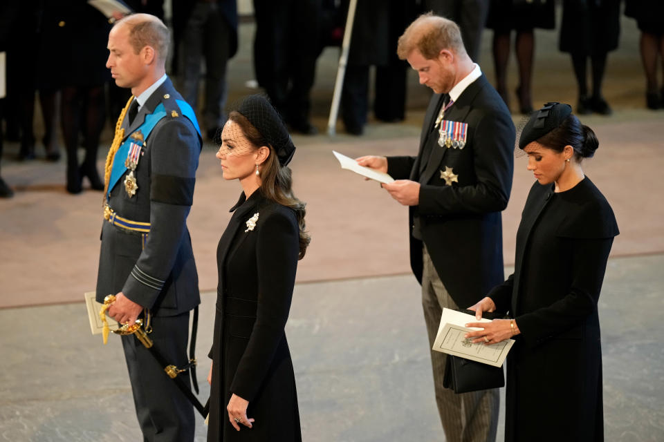 LONDON, ENGLAND - SEPTEMBER 14: Prince William, Prince of Wales, Catherine, Princess of Wales, Prince Harry, Duke of Sussex and Meghan, Duchess of Sussex pay their respects inside the Palace of Westminster during the Lying-in State of Queen Elizabeth II on September 14, 2022 in London, England. Queen Elizabeth II's coffin is taken in procession on a Gun Carriage of The King's Troop Royal Horse Artillery from Buckingham Palace to Westminster Hall where she will lay in state until the early morning of her funeral. Queen Elizabeth II died at Balmoral Castle in Scotland on September 8, 2022, and is succeeded by her eldest son, King Charles III.  (Photo by Christopher Furlong/Getty Images)