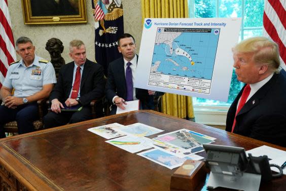 Donald Trump addresses reporters while holding doctored map (Getty Images)