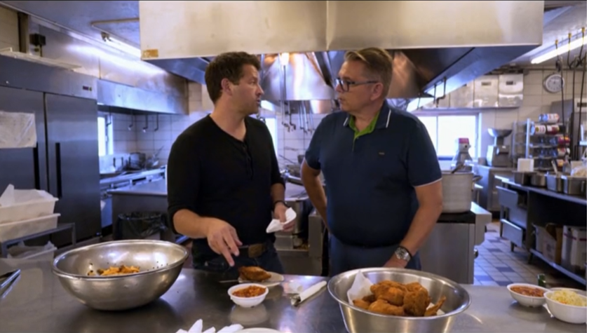 "Roadfood" host Misha Collins, left, and Milos Papich, owner of Belgrade Gardens in Barberton, talk about Barberton chicken for the new PBS show.
