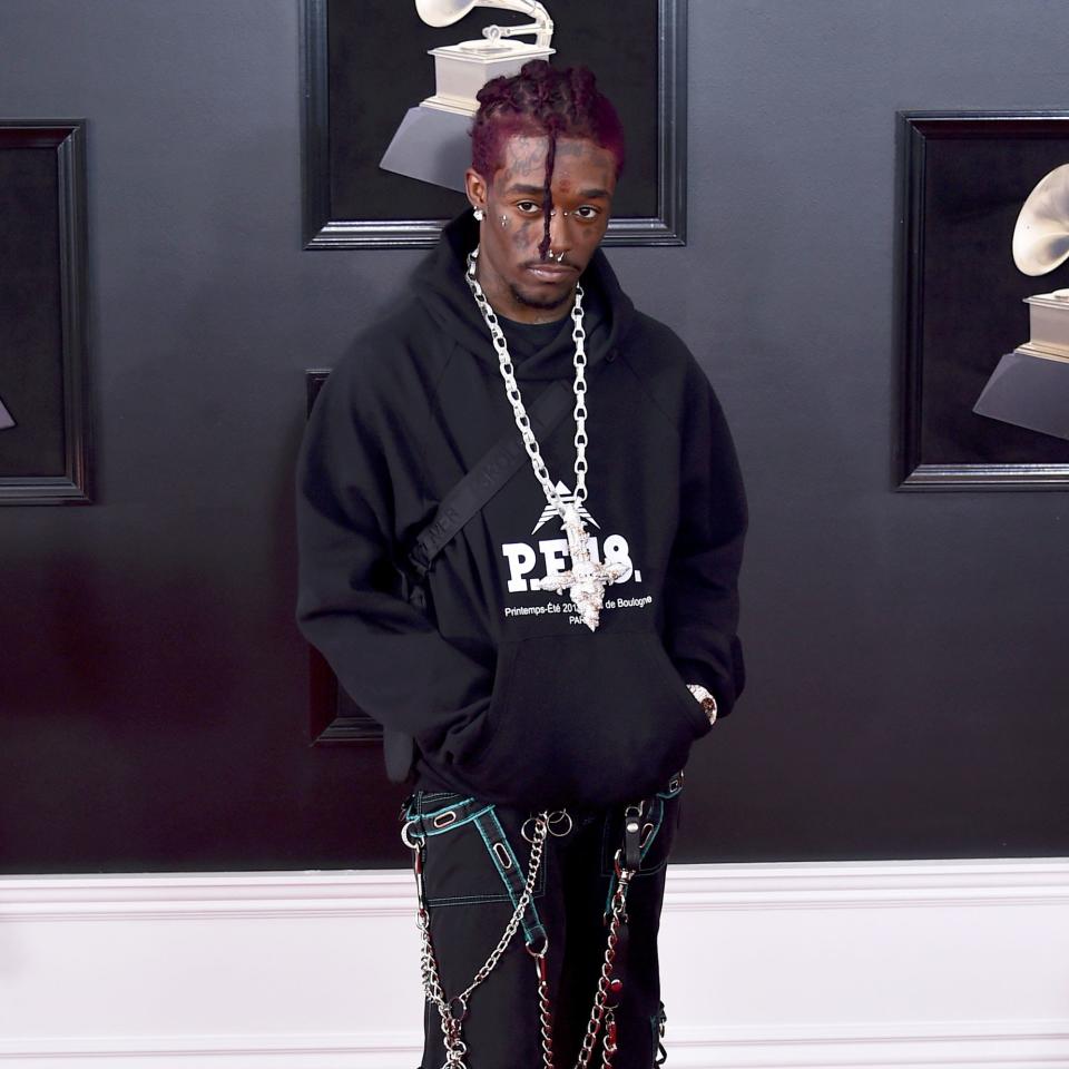 Lil Uzi Vert brings his signature rocker edge to the Grammys red carpet wearing baggy rave pants with confidence.