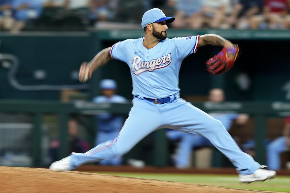 Texas Rangers relief pitcher Matt Bush winds up to throw to the Minnesota Twins in the seventh inning of a baseball game, Sunday, July 10, 2022, in Arlington, Texas. (AP Photo/Tony Gutierrez)