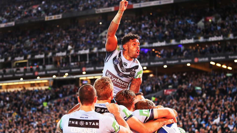 Joshua Addo-Carr jumps on teammates and celebrates a try in State of Origin.