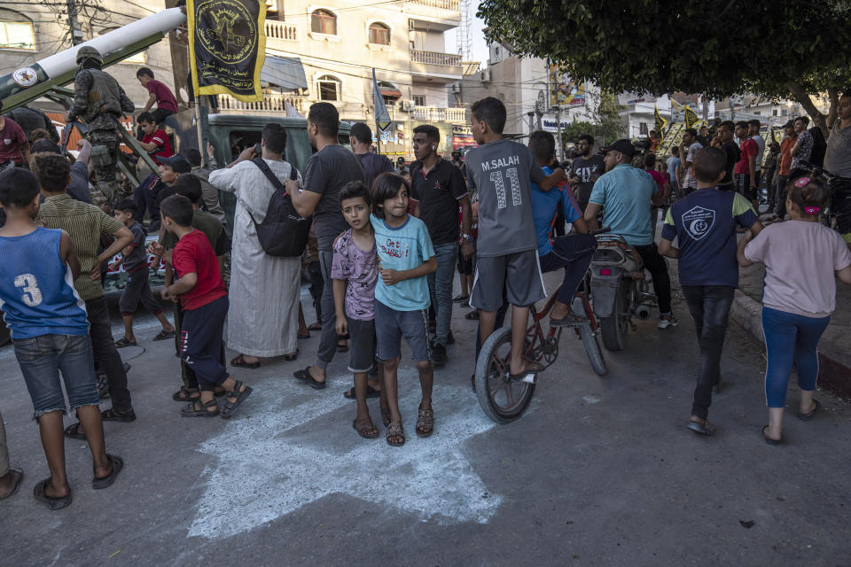 Children react as Palestinian Islamic Jihad fighters take part in an anti-Israel rally in Rafah, south of Gaza City, Wednesday, Aug. 24, 2022. (AP Photo/Fatima Shbair)