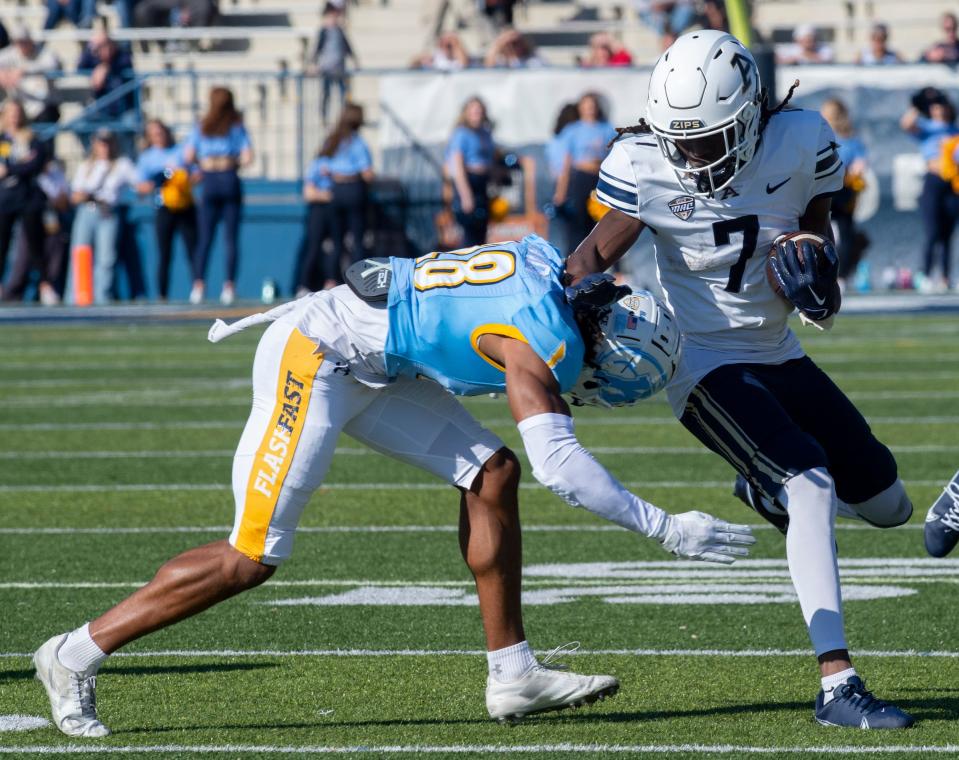 Alex Branch lowers to tackle Alex Adams. Wagon Wheel rivalry game between Kent State and University of Akron in Kent on Saturday October 22. Kent State wins the wheel, 33-27.