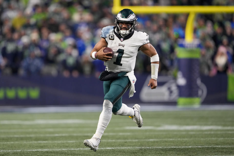 Philadelphia Eagles quarterback Jalen Hurts runs with the ball against the Seattle Seahawks during the second half of an NFL football game, Monday, Dec. 18, 2023, in Seattle. (AP Photo/Lindsey Wasson)