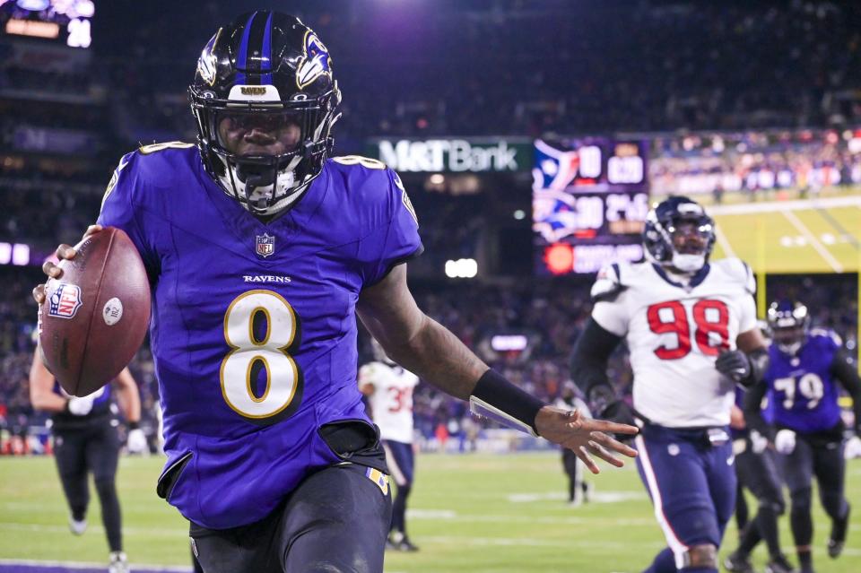 Baltimore Ravens quarterback Lamar Jackson (8) reacts after running past for Houston Texans defensive tackle Sheldon Rankins (98) for a touchdown during the fourth quarter in a 2024 AFC divisional round game at M&T Bank Stadium in Baltimore, Maryland on Jan 20, 2024.