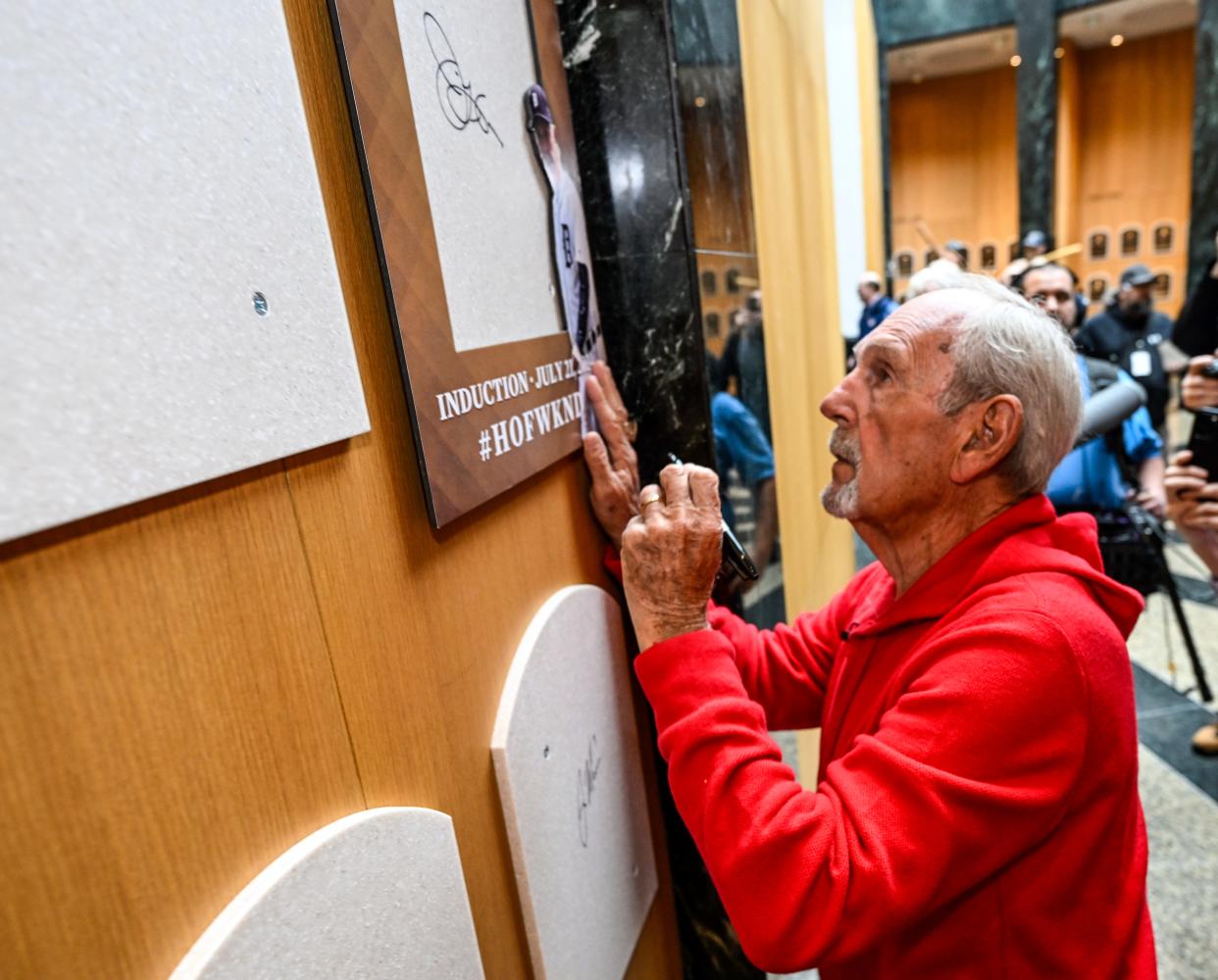 Newly elected Baseball Hall of Fame inductee Jim Leyland signs his name to the backer board of his plaque during a news conference Tuesday, Jan. 30, 2024, in Cooperstown, New York.