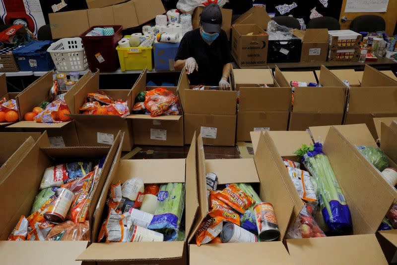 Workers prepare free food for distribution at the Chelsea Collaborative in Chelsea