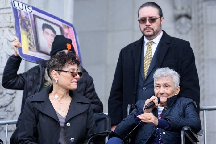 two women sit giving a speech at a protest for justice for Keita O'Neil