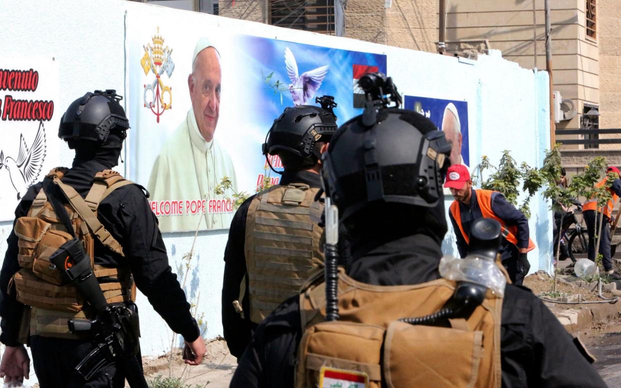 Iraqi security forces patrol around the Cathedral of Saint Joseph in Baghdad  - SABAH ARAR /AFP