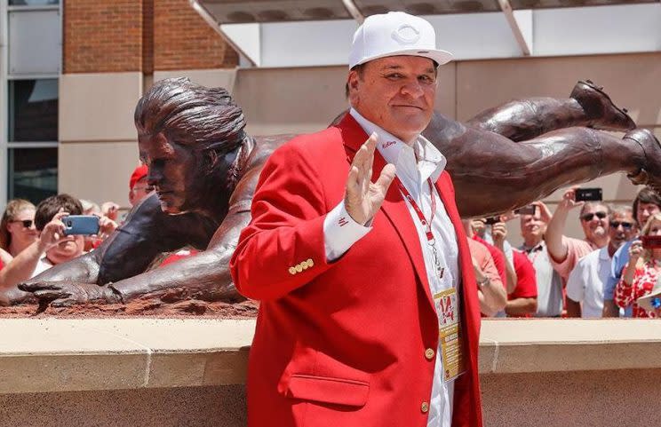 Pete Rose poses with his new bronze statue outside Great American Ballpark. (Reds)