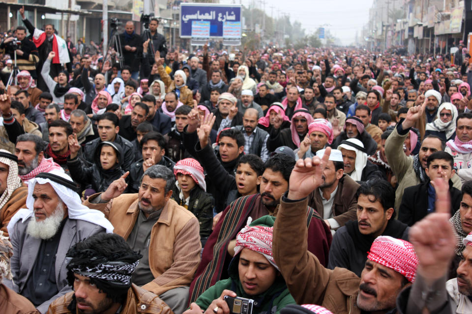 Sunni Muslim worshippers crowd a street as they attend open air Friday prayers in Fallujah, 40 miles (65 kilometers) west of Baghdad, Iraq, Friday, Jan. 3, 2014. Provincial spokesman Dhari al-Rishawi said Iraqi security forces and allied tribesmen are pressing their campaign to rout al-Qaida from Fallujah and Ramadi, two main cities in the western Anbar province. (AP Photo)