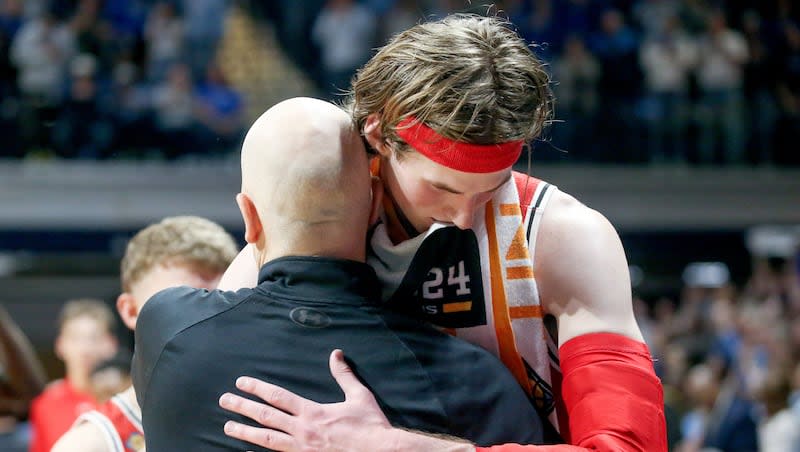 Utah Utes head coach Craig Smith hugs center Branden Carlson (35) after Utah lost an NIT semifinal basketball game against the Indiana State Sycamores at the Hinkle Fieldhouse in Indianapolis on Tuesday, April 2, 2024.