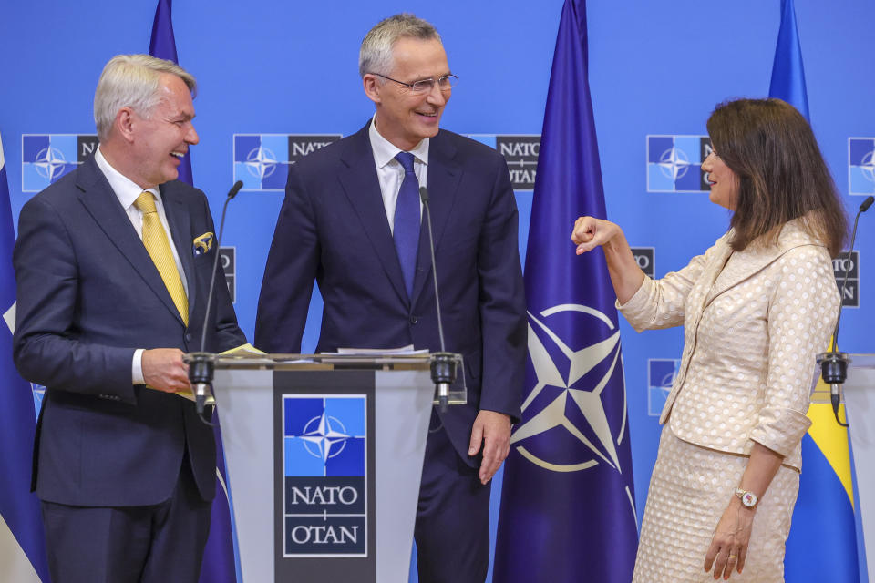 FILE - Finland's Foreign Minister Pekka Haavisto, left, Sweden's Foreign Minister Ann Linde, right, and NATO Secretary General Jens Stoltenberg attend a media conference after the signature of the NATO Accession Protocols for Finland and Sweden in the NATO headquarters in Brussels, on July 5, 2022. By ending 77 years of almost uninterrupted peace in Europe, war in Ukraine war has joined the dawn of the nuclear age and the birth of manned spaceflight as a watershed in history. After nearly a half-year of fighting, tens of thousands of dead and wounded on both sides, massive disruptions to supplies of energy, food and financial stability, the world is no longer as it was.(AP Photo/Olivier Matthys)