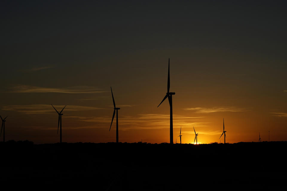 The sun sets behind a wind farm near Del Rio, Texas, Wednesday, Feb. 15, 2023. Some landowners along the Devil's River argue that proposed wind turbines would kill birds, bats and disrupt monarch butterflies migrating to Mexico and impact ecotourism, a main source of income for many. (AP Photo/Eric Gay)